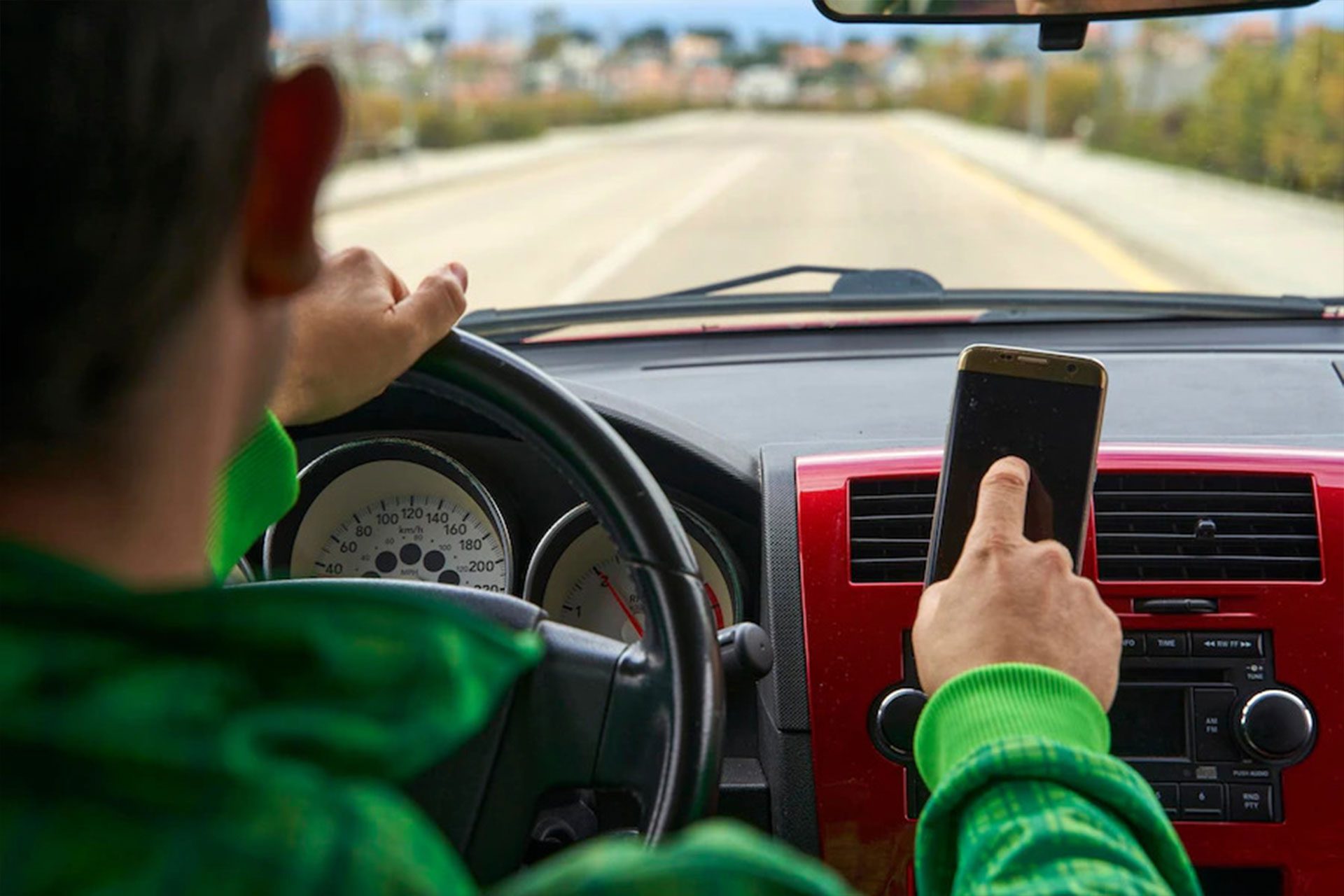 male-driver-touching-smartphone-screen-dashboard-while-he-are-driving_672594-71